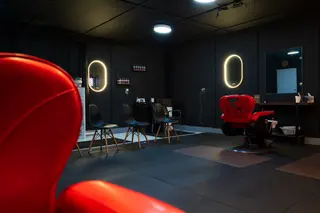 Barbershop interior with a red chair in the foreground