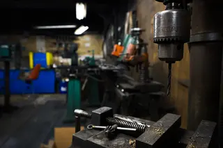Drill press and metal vice on a workshop bench