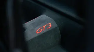 Close detail of red GT3 lettering on a sports-car seat