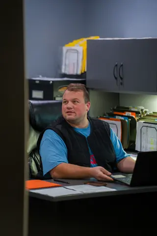 Person seated at a desk in a workplace office