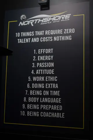 Framed motivational sign on a dark wall