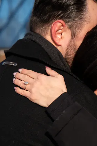 Engagement ring visible during a close embrace