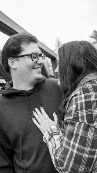 Black-and-white portrait of a couple looking at one another