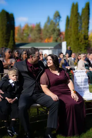 Wedding guests seated together at an outdoor ceremony