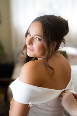 Close portrait of the bride looking over her shoulder