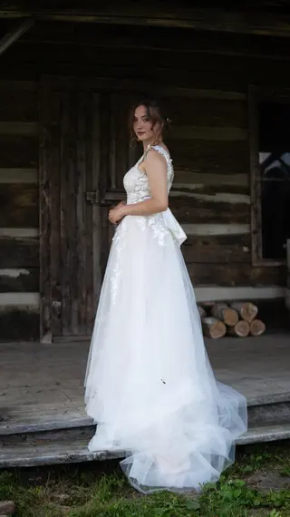 Bride looking back from the porch of a wooden building
