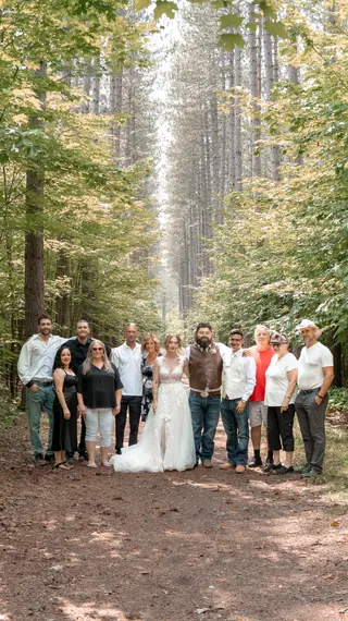 Wide forest setting surrounding the wedding group
