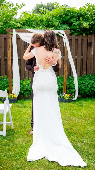 Bride and groom embracing in a garden